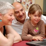 grandparents with grandkids at the computer